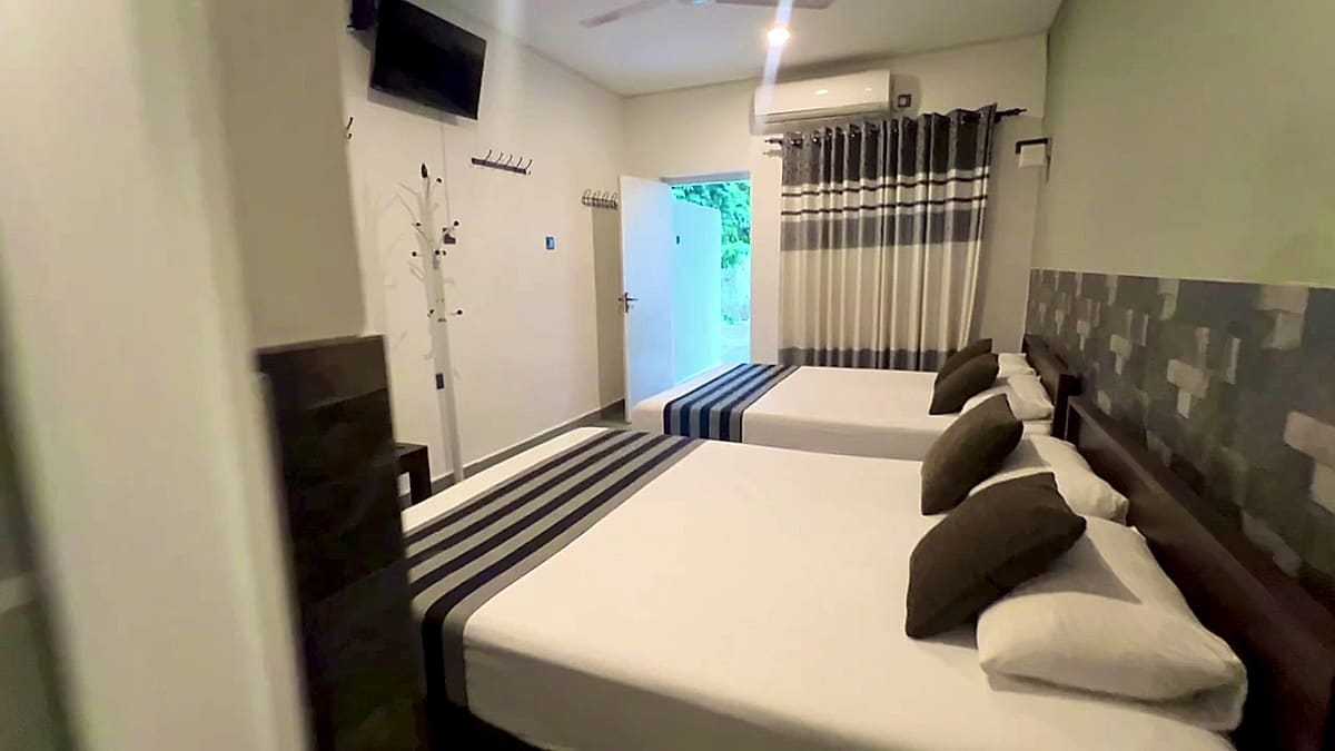 Wide view of the family room with two beds and air conditioning